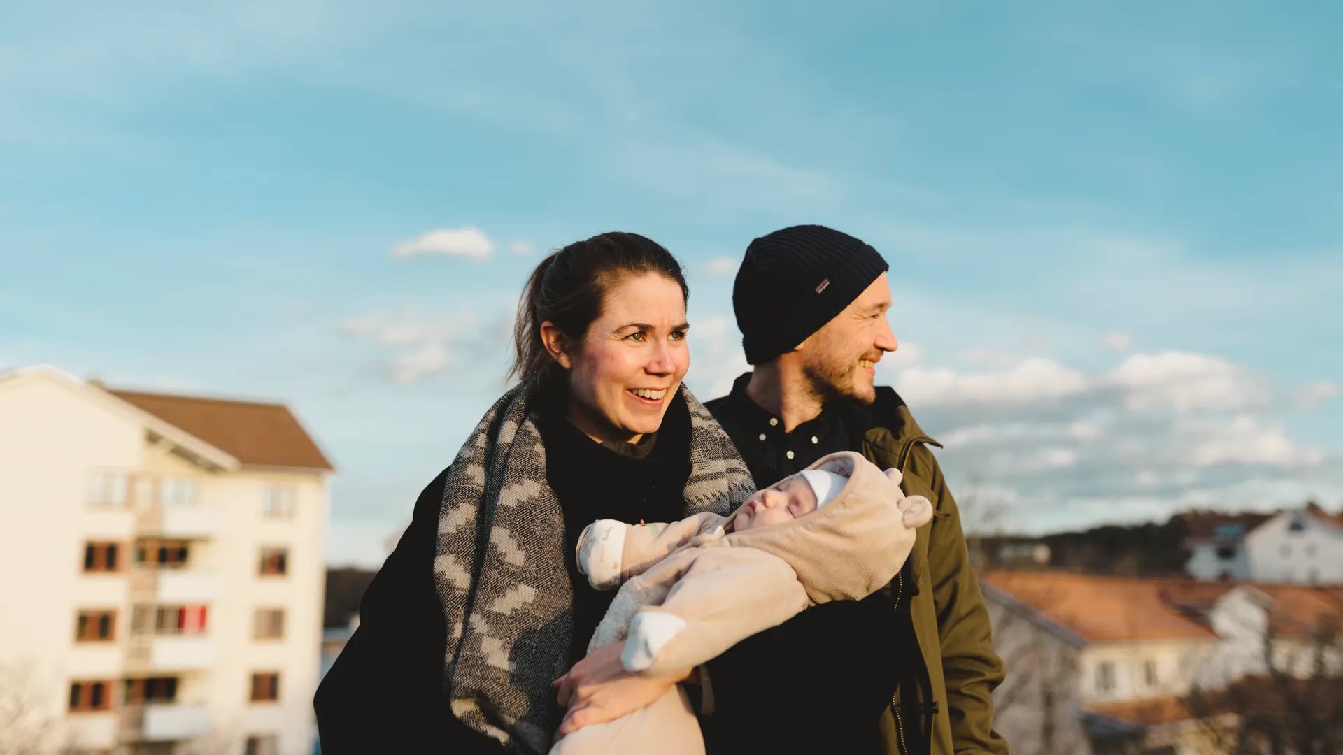 En man och en kvinna som håller en bebis i famnen.